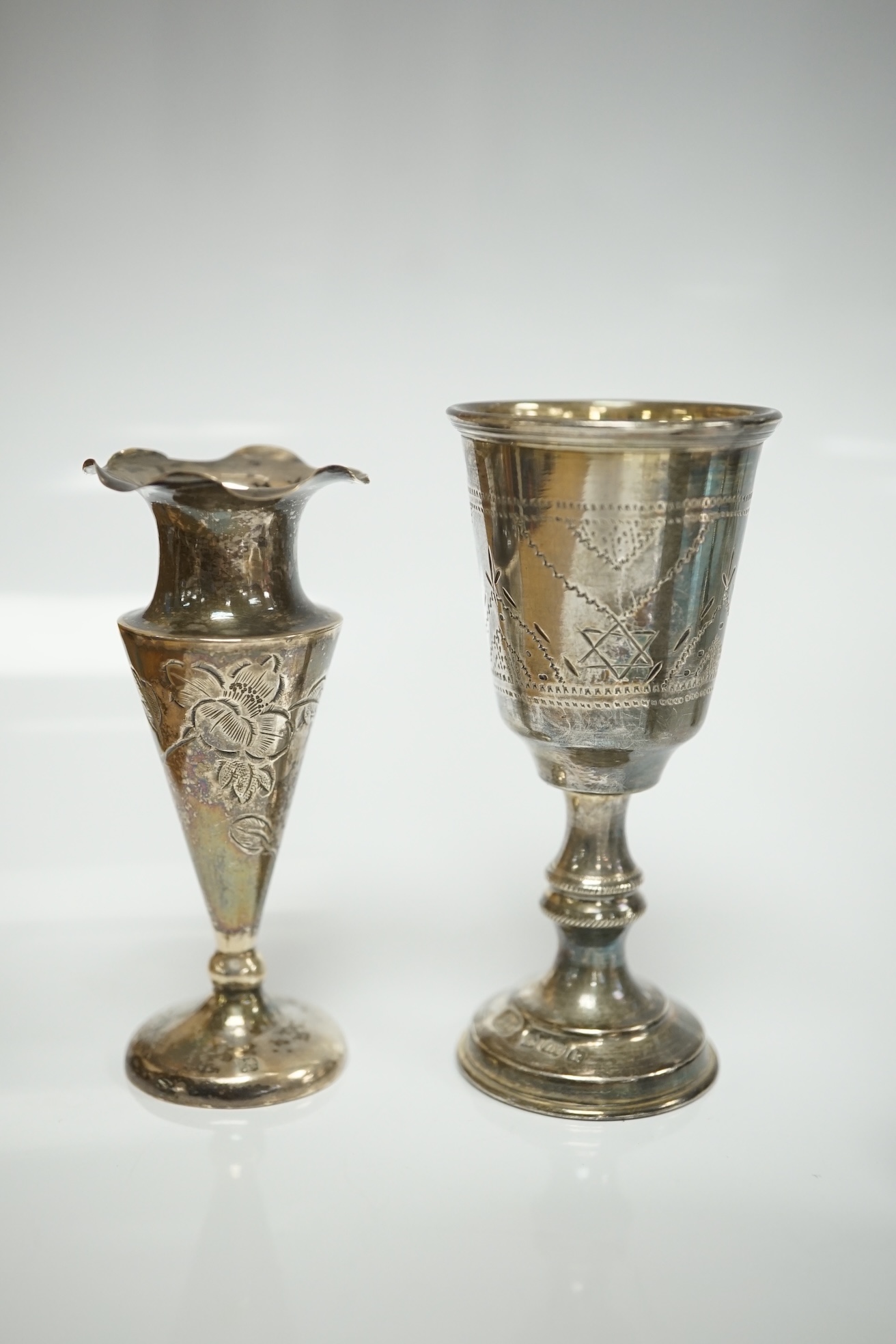 A small collection of miniature silver and white metal items including a cot by Saunders & Shepherd, Birmingham, 1896, 57mm, two filigree items, two Kiddush cups etc. Condition - poor to fair